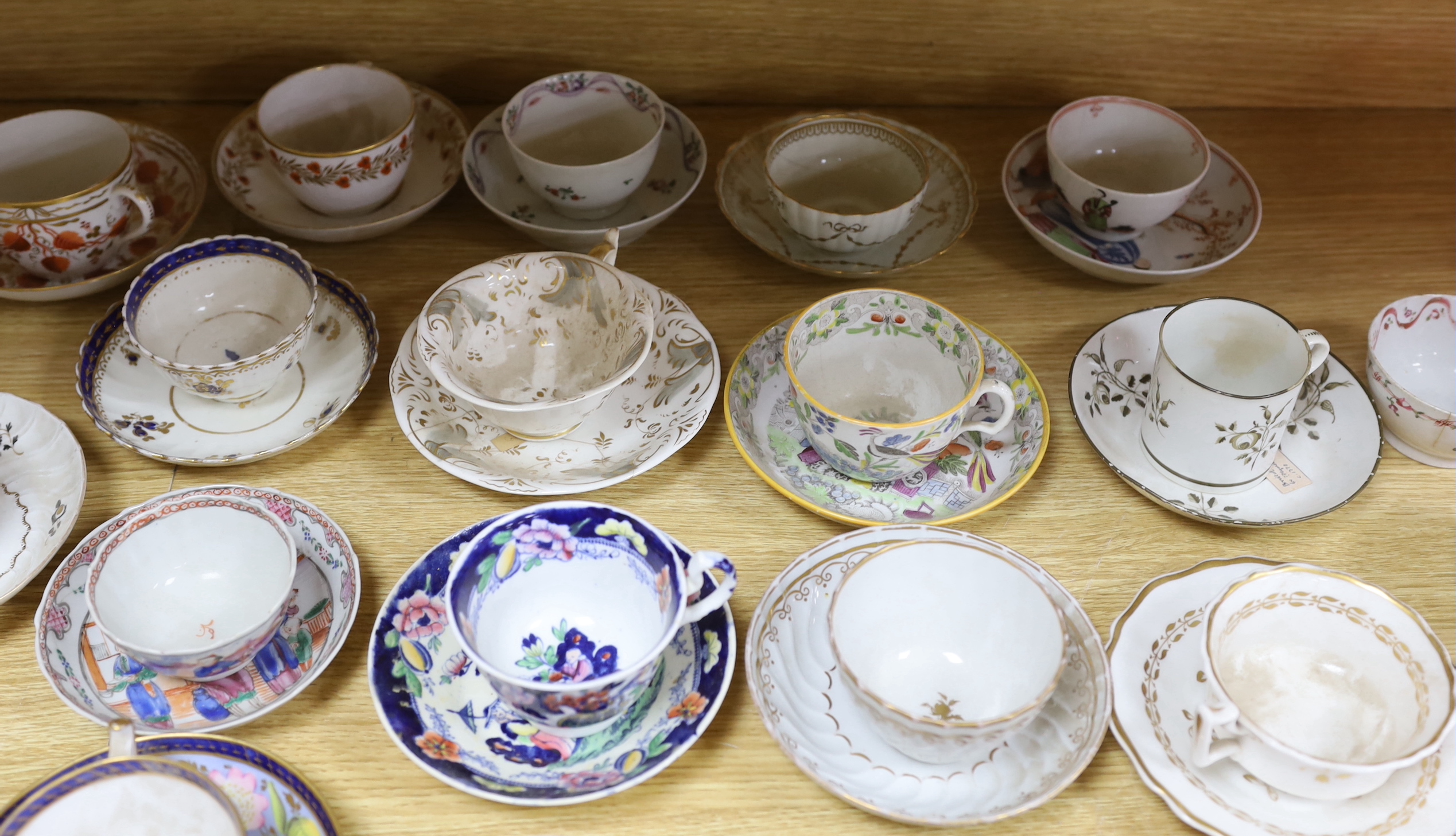 Collection of 18th/19th century English porcelain tea and coffee cups, bowls and saucers, some with hand painted and gilded decoration, the largest 15cm in diameter